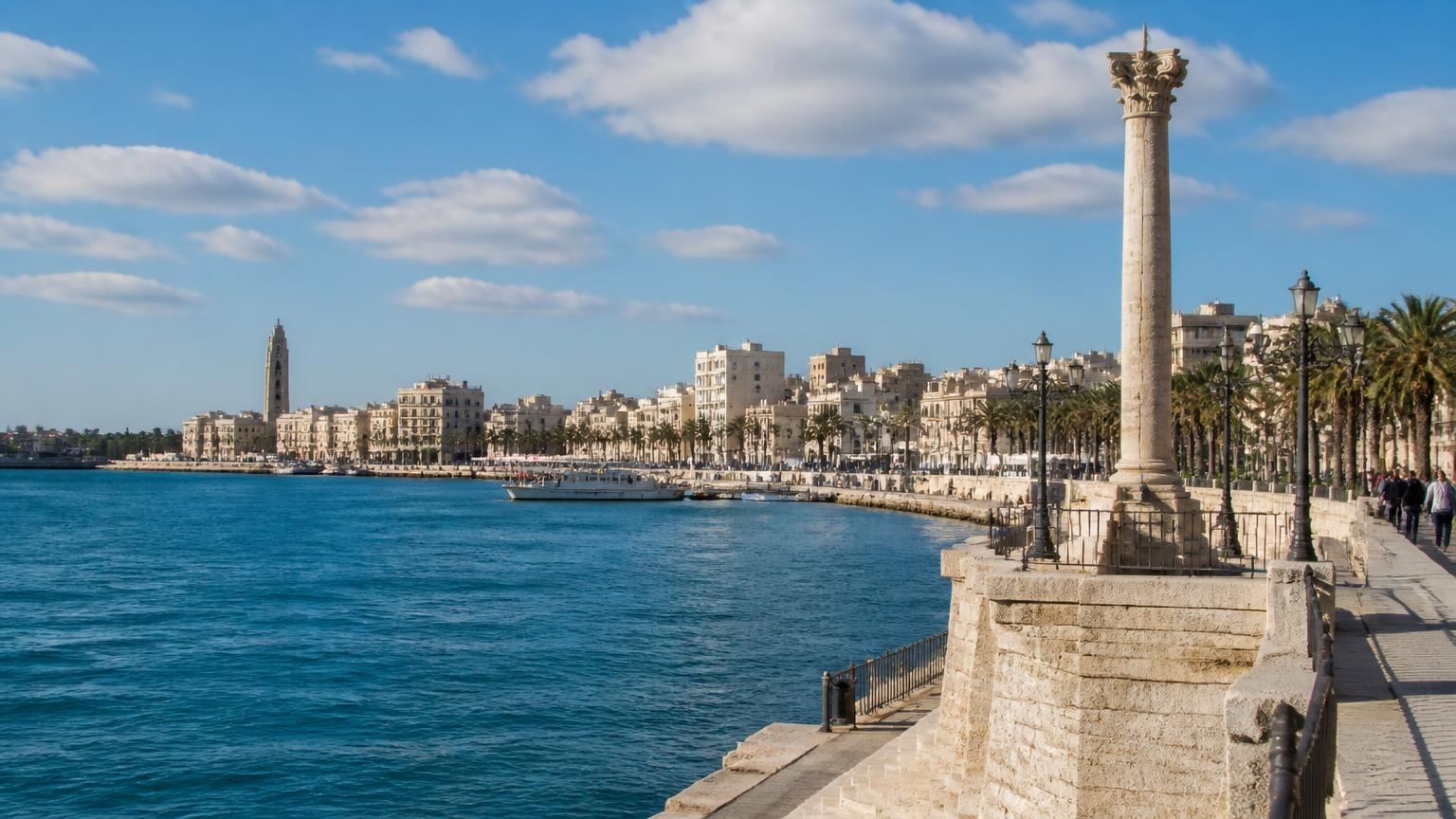 The Brindisi waterfront: a Roman column on its base above the harbour, with a palm-lined promenade running along the water